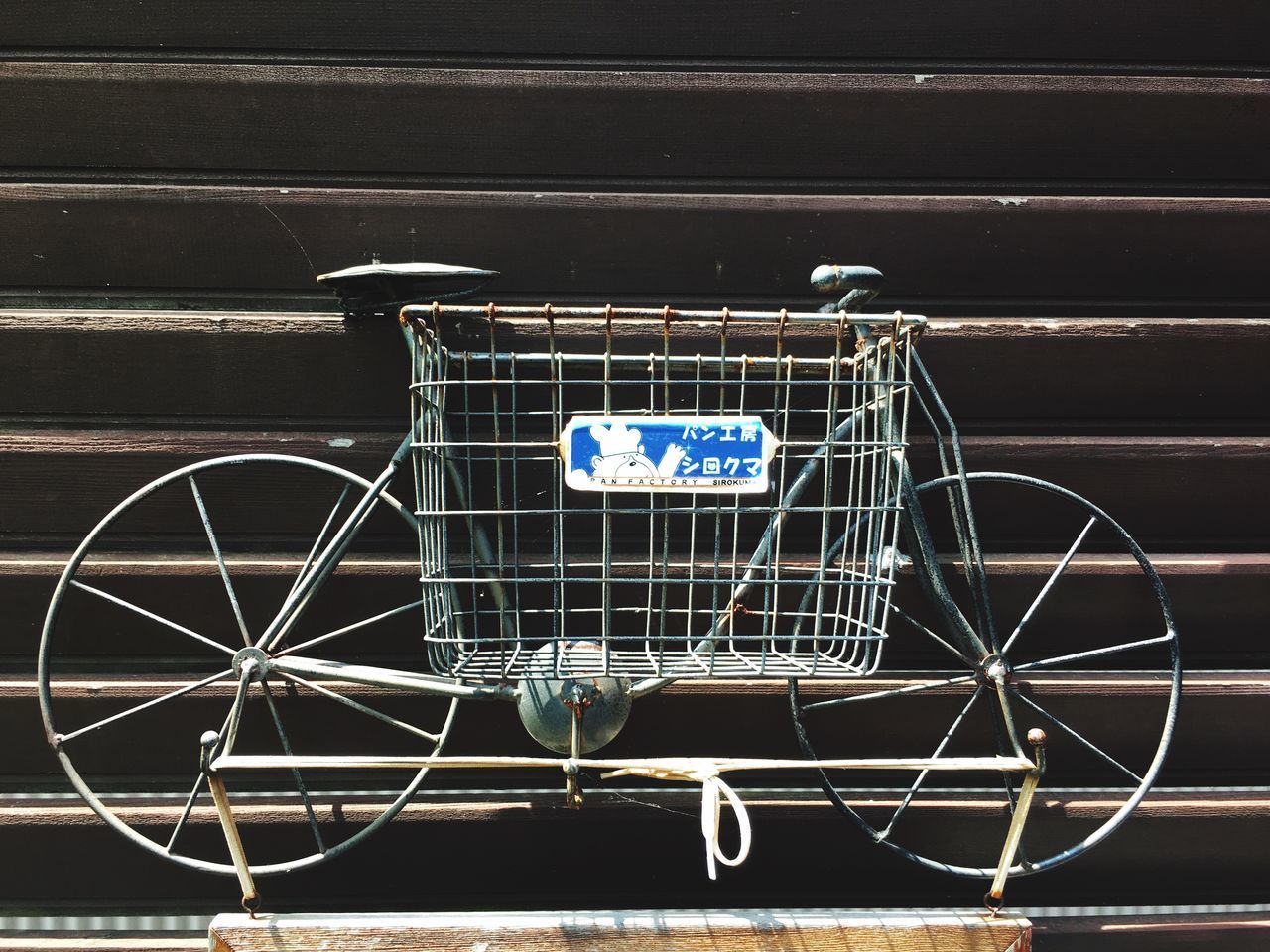 CLOSE-UP OF BICYCLE AGAINST BLUE WALL