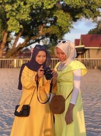 Two woman photographing with camera