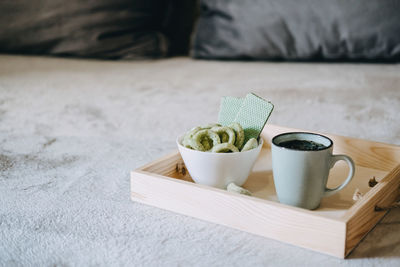 Cbd edibles, cbd-infused snacks, hemp wafers with cannabis. testy cbd snacks in bowl and cup of  tea