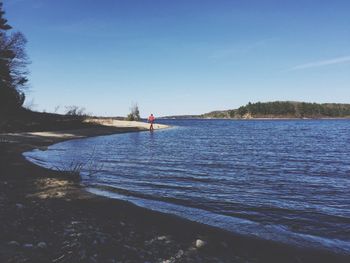 Calm lake against blue sky