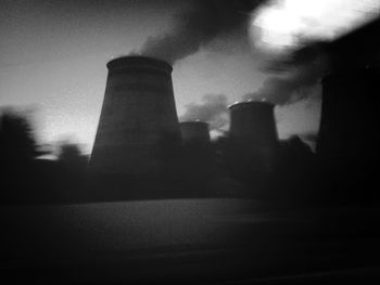 Smoke emitting from chimney against sky