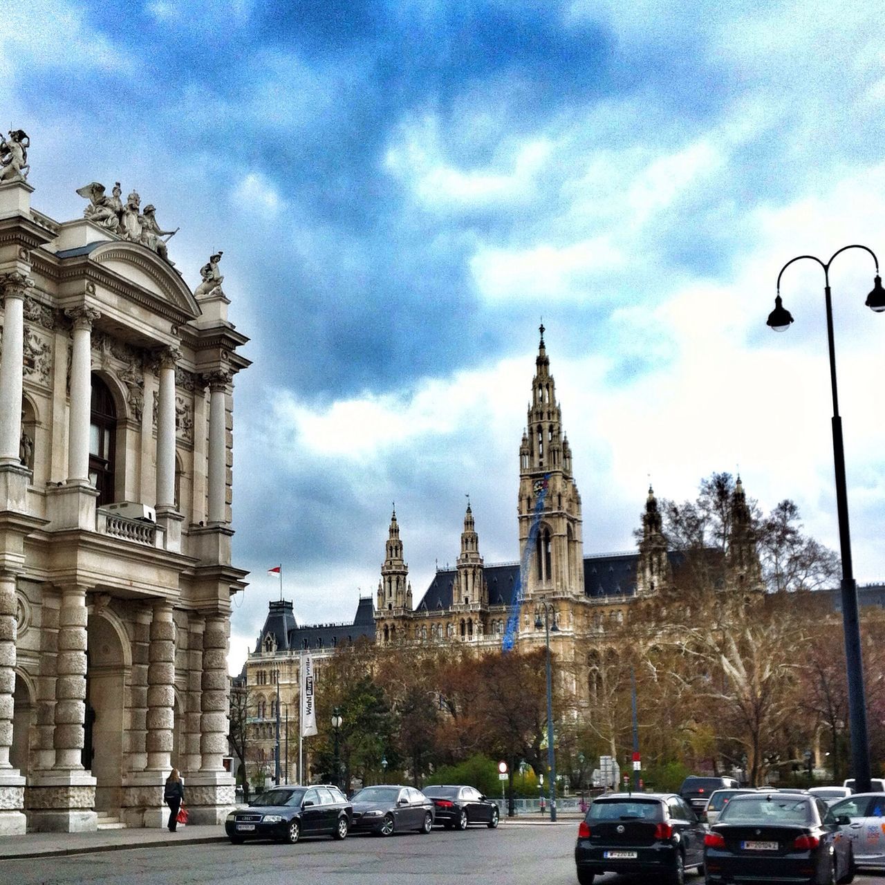 architecture, car, built structure, land vehicle, building exterior, transportation, mode of transport, sky, travel, street, city, famous place, travel destinations, cloud - sky, history, incidental people, road, tourism, capital cities, international landmark