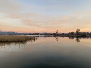 Scenic view of lake against sky during sunset