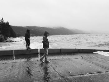 People at beach against sky