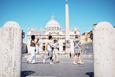 People in front of built structure