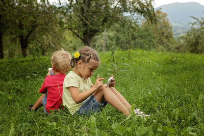 Side view of woman sitting on field