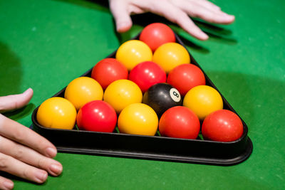 Cropped hands adjusting balls on pool table