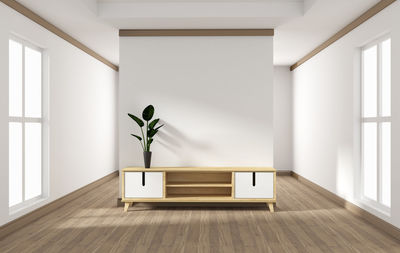 Empty chair against white wall at home
