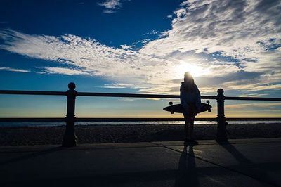 Silhouette of people standing on beach