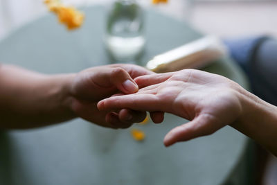 Cropped hand of woman holding hands