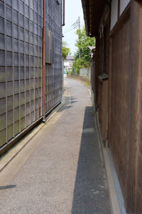 Empty road amidst buildings in city