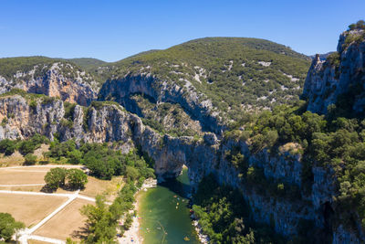 Scenic view of mountains against blue sky