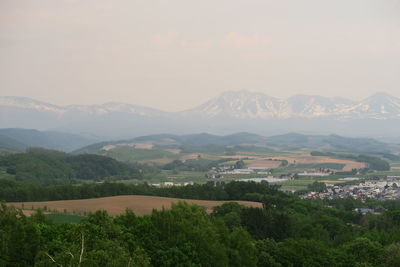 Scenic view of townscape against mountains