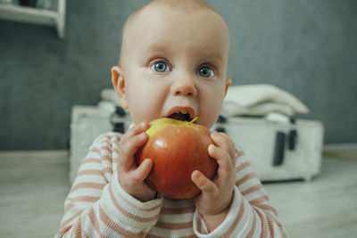 Cute kid eating a big apple