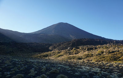 View of volcanic mountain against blue sky