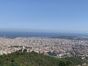 High angle view of townscape against clear blue sky