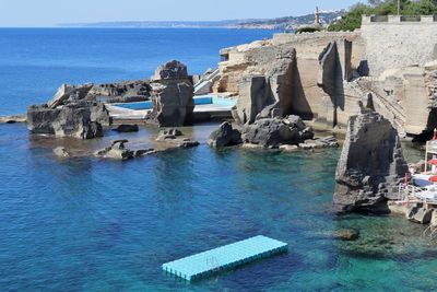 Panoramic view of sea and buildings against sky