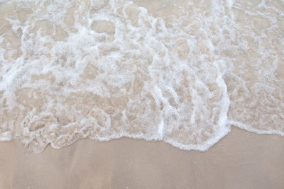 High angle view of surf on beach