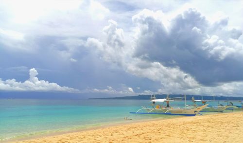 Scenic view of sea against cloudy sky