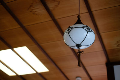 Low angle view of lantern hanging from ceiling at shirahata shrine