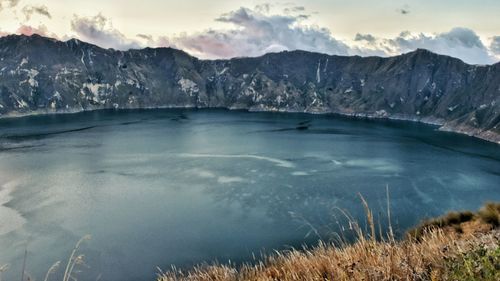 Scenic view of lake and mountains against sky