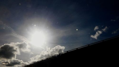 Low angle view of sun shining in sky