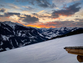 Scenic view of snow covered mountains against sky during sunset