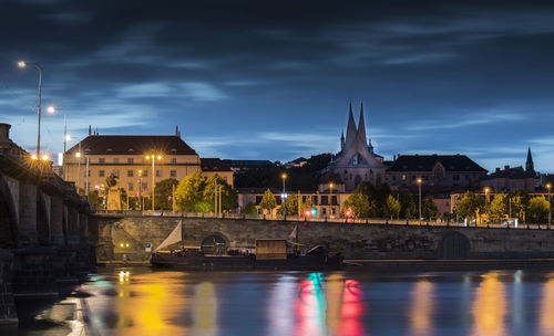 View of illuminated bridge over river against cloudy sky