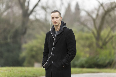 Portrait of young man standing outdoors