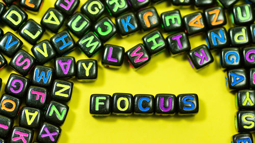 Focus text with colorful alphabet blocks on yellow background