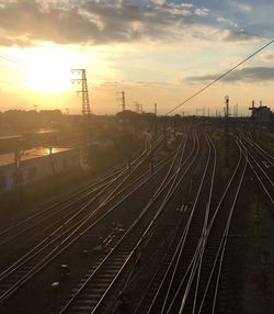 Railroad tracks against sky during sunset