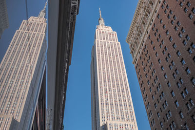 Low angle view of modern buildings against clear sky