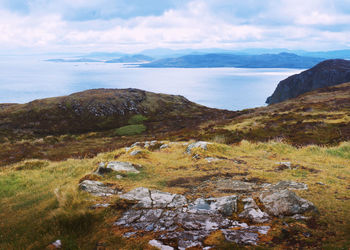 Scenic view of sea and mountains against sky