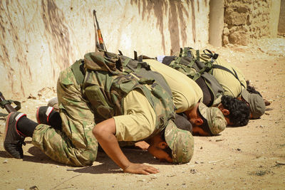 Soldiers praying outdoors