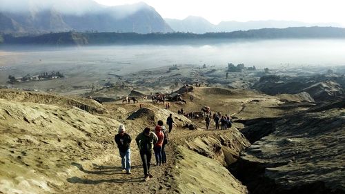 Large group of people at arid landscape 