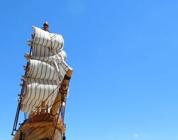 Low angle view of statue against clear blue sky