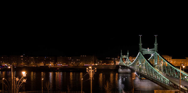 Liberty bridge over danube river at night