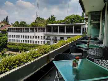 View of swimming pool by building against sky