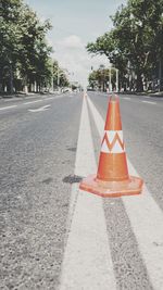 Traffic cones on road against sky