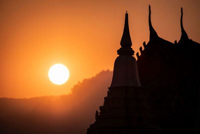 Silhouette temple against sky during sunset