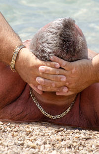 Close-up of woman hand with tattoo on water