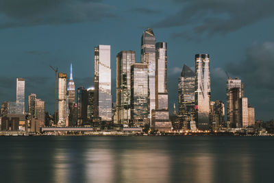 Manhattan midtown skyline, seen from across the hudson river at night. beautiful reflections 