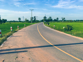 Country road passing through field