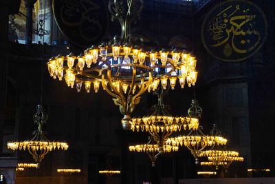 Illuminated chandeliers in room at night