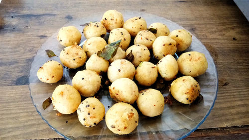 Suji appe or rice appe or appam, an indian snack with onion, peanuts and tamarind dip in india