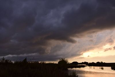 Scenic view of lake against sky during sunset
