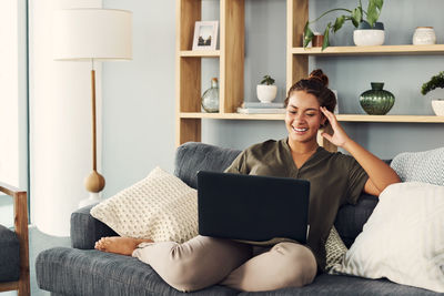 Woman using mobile phone at home