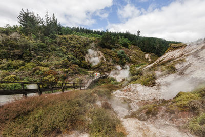 Scenic view of waterfall against sky