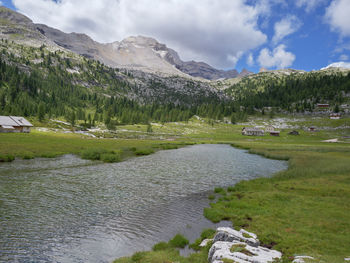 Scenic view of lake and mountains against sky