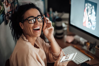 Portrait of a smiling young woman using mobile phone